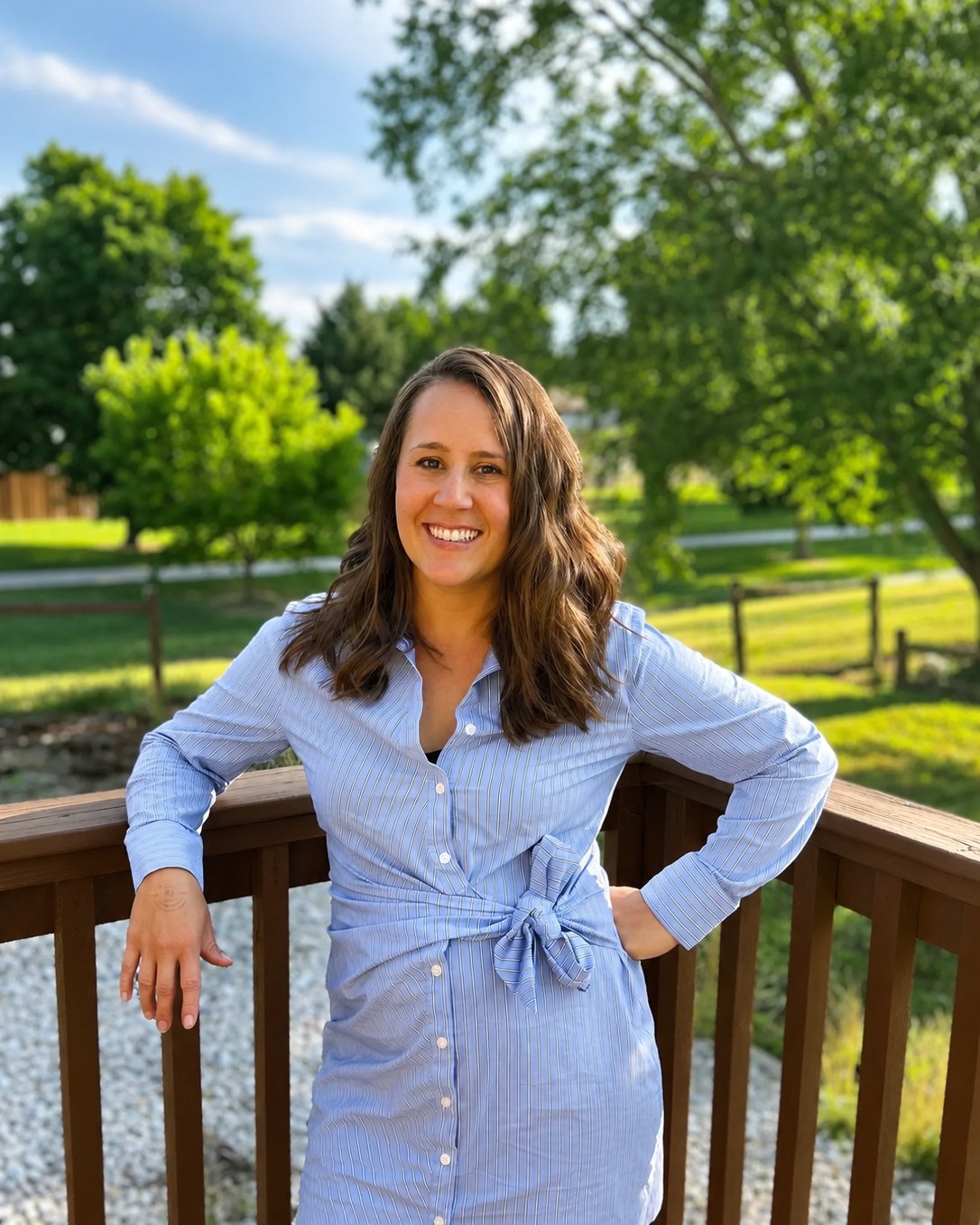 Shayla Martinez-O'Brien outdoors on a wooden deck surrounded by trees.